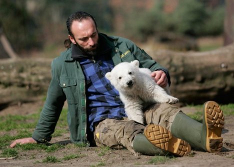 File photo of Berlin zoo employee Doerflein playing with polar bear cub Knut during the bear's first presentation in Berlin